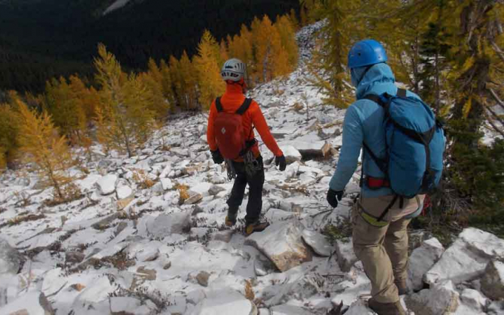 two students descend a rocky landscape on a mountaineering course with outward bound